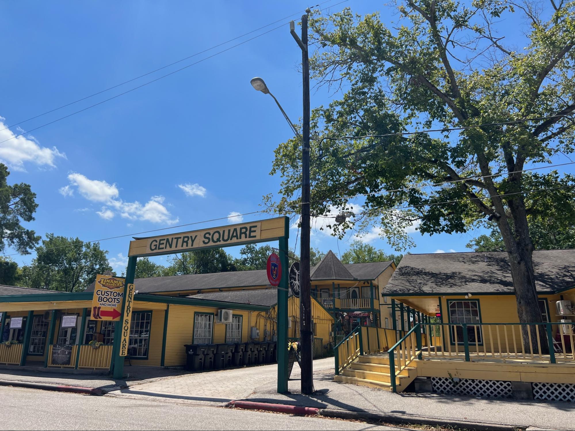Gentry Square storefronts in Old Town Spring under a blue sky